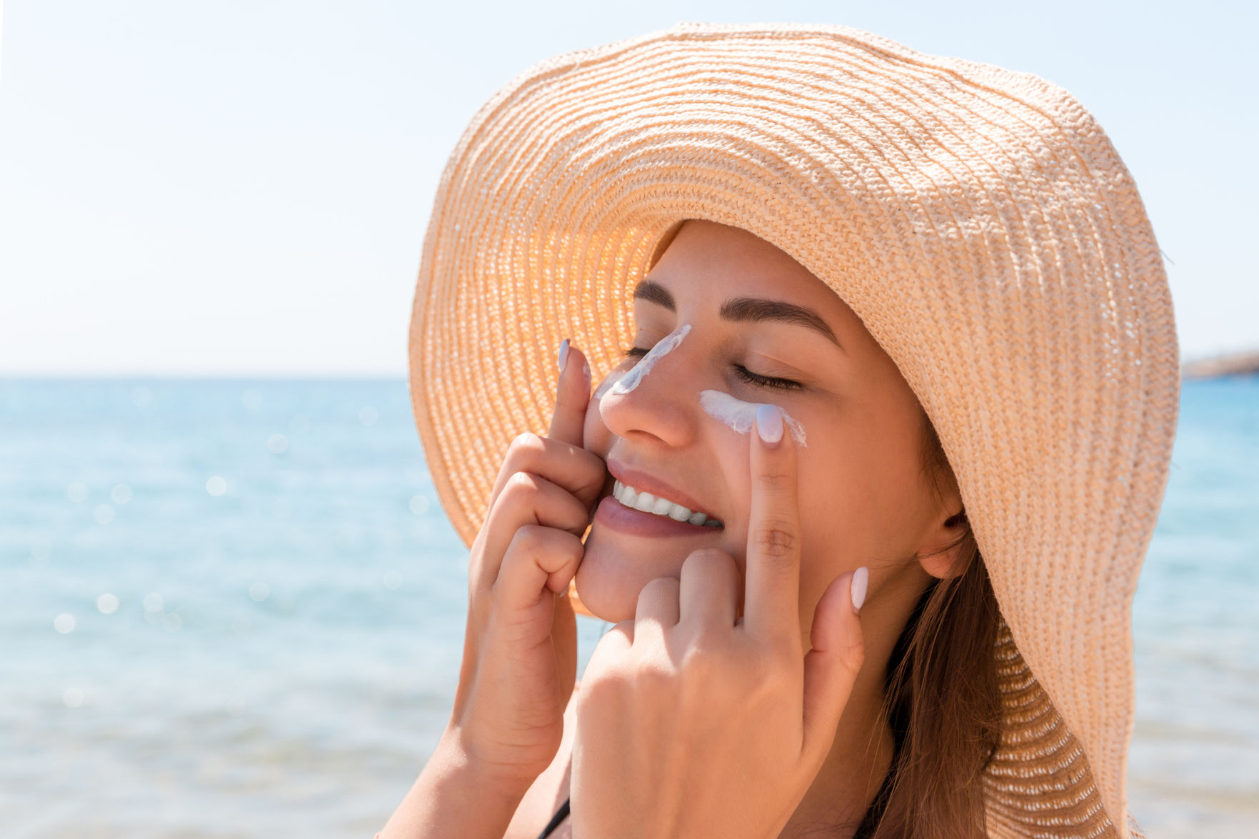 Woman applying sunscreen